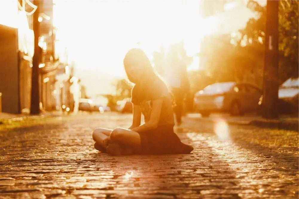 Girl sitting on pavement